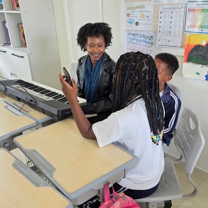 Music lesson with teacher and students at a keyboard