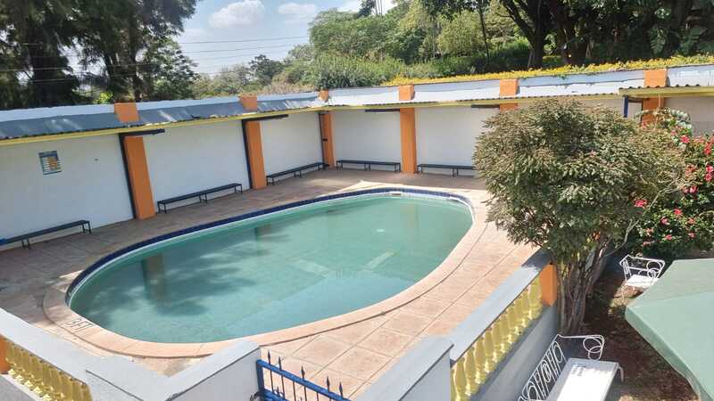 School swimming pool surrounded by covered seating areas