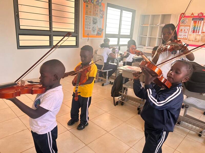 Students learning violin in a music class